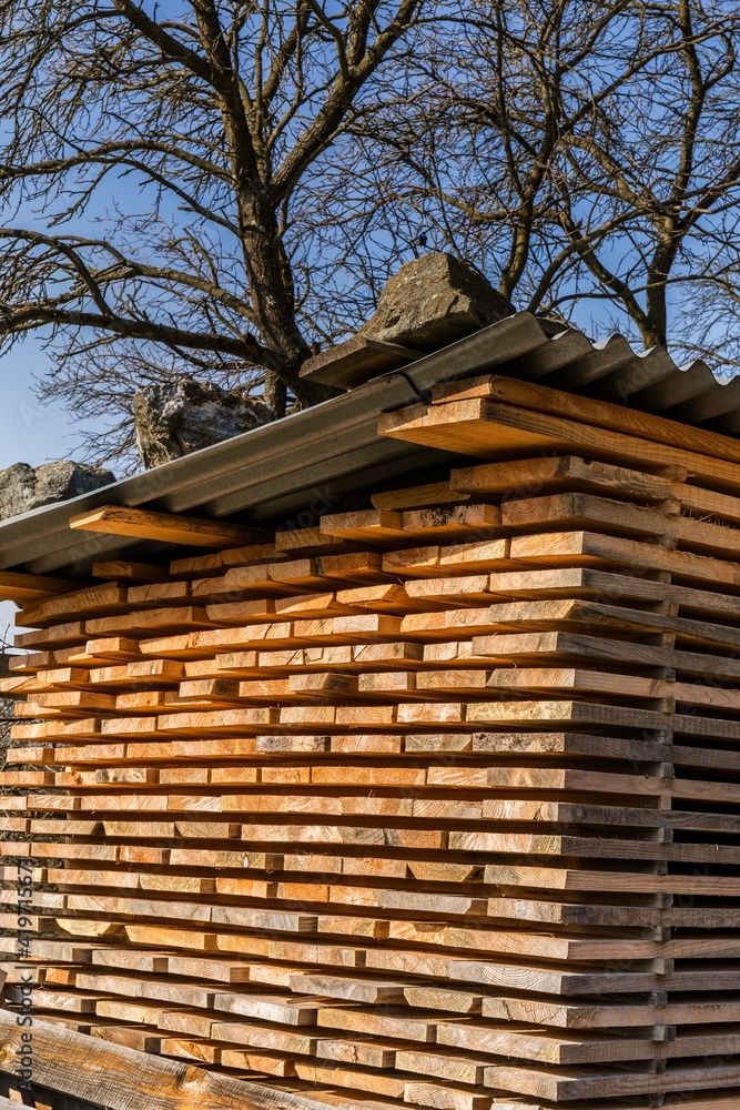Wooden planks and beams. Air-drying timber stack. Wood air drying. Wood for house construction. Building material. Wood warehouse. Wooden planks and beams. Air-drying timber stack. Wood air drying. Wood for house construction. Building material. Wood warehouse.