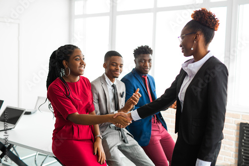 team of young african people in office with handshake 