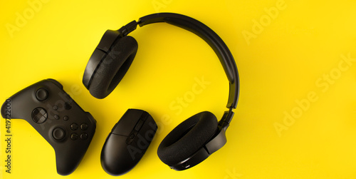 Gamer flat lay. Gaming accessories on yellow background with copy space.Gamer gadgets. 