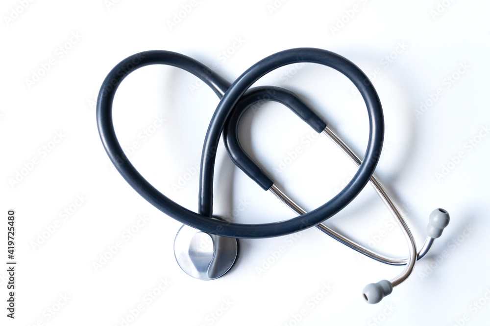 Stethoscope forming a heart on white background. Concept of care, health and wellness. Stethoscope forming a heart on white background. Concept of care, health and wellness.