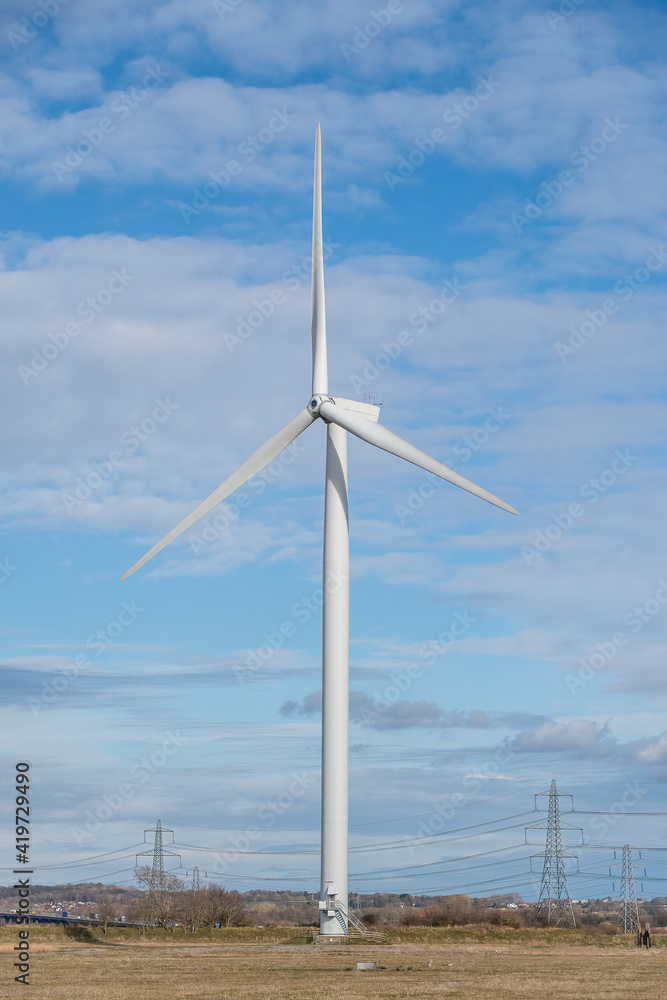 Renewable energy wind turbine in a field
