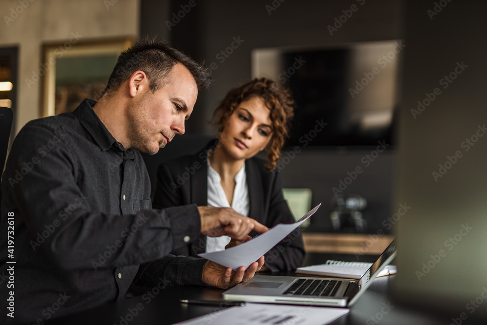 Dressed elegant, man explaining something to woman. Dressed elegant, man explaining something to woman.