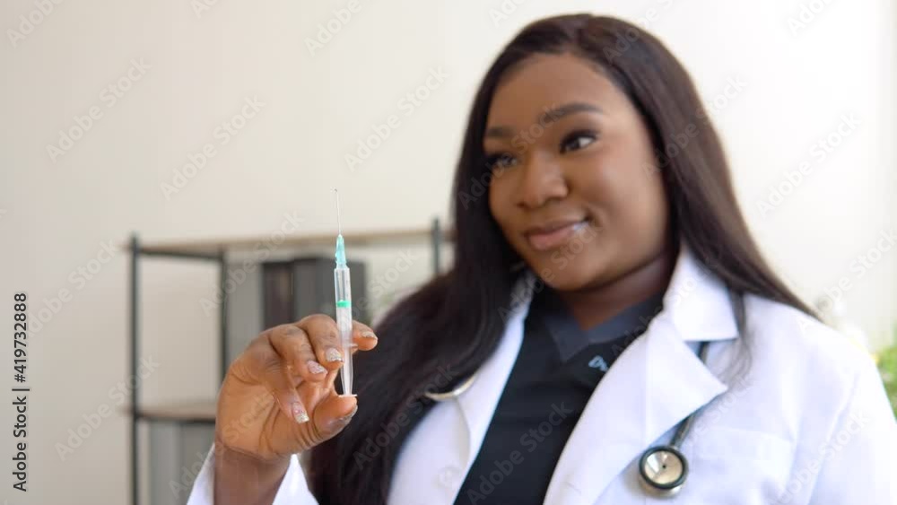 African American female doctor preparing an injection African American female doctor preparing an injection