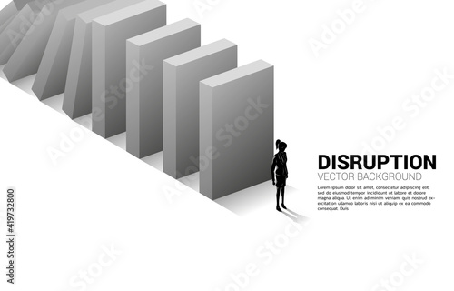 Silhouette of businesswoman standing at the end of domino collapse. Concept of business industry disrupt
