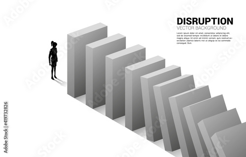 Silhouette of businesswoman standing at the end of domino collapse. Concept of business industry disrupt