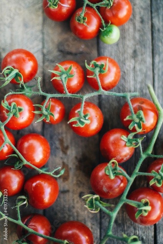 red cherry tomatoes on wooden background