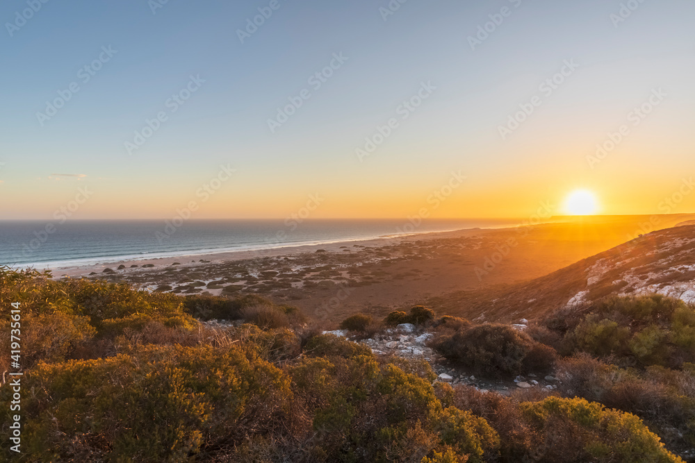 Sunset over sandy coastal beach in Nullarbor National Park Sunset over sandy coastal beach in Nullarbor National Park