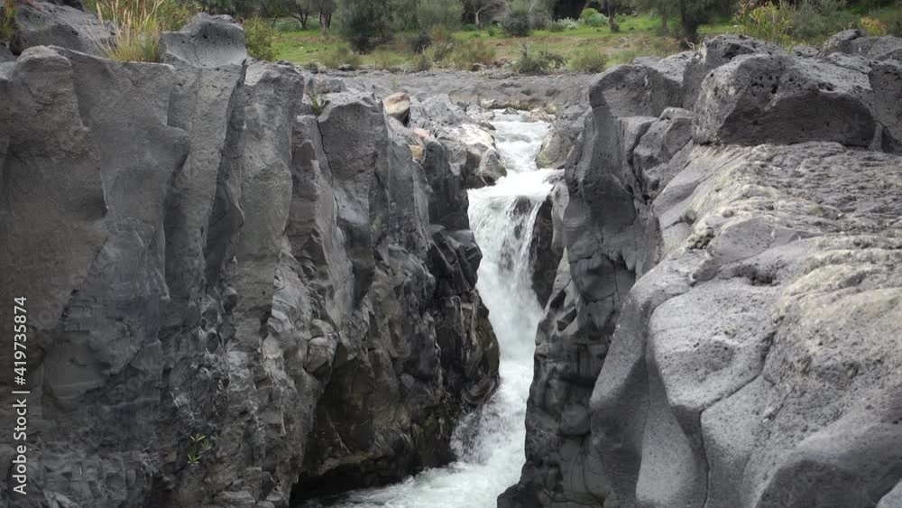 volcanic rock of Sicily nature split by a fault and smoothed by the waters flowing in a gorge of Simeto river
volcanic rock of Sicily nature split by a fault and smoothed by the waters flowing in a gorge of Simeto river