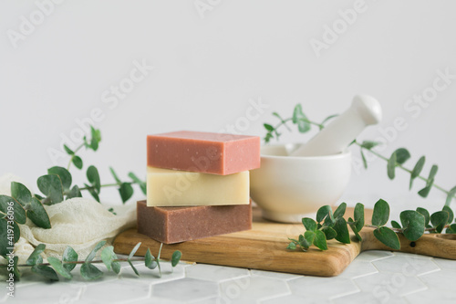 Natural bars of homemade soap on white background photo