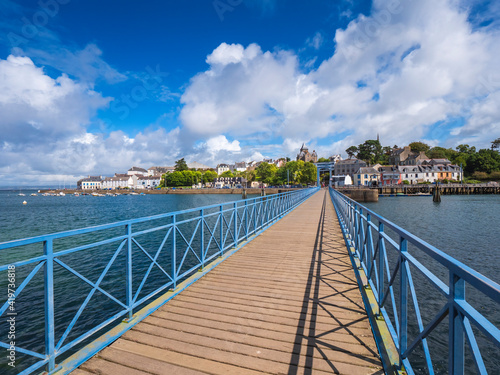 Bridge over sea against cloudy sky