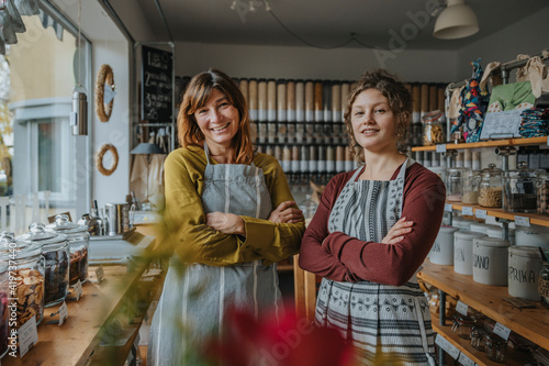 Smiling female saleswoman and owner with arms crossed at zero waste store photo