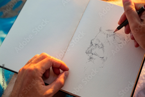 Man doing sketch in book photo