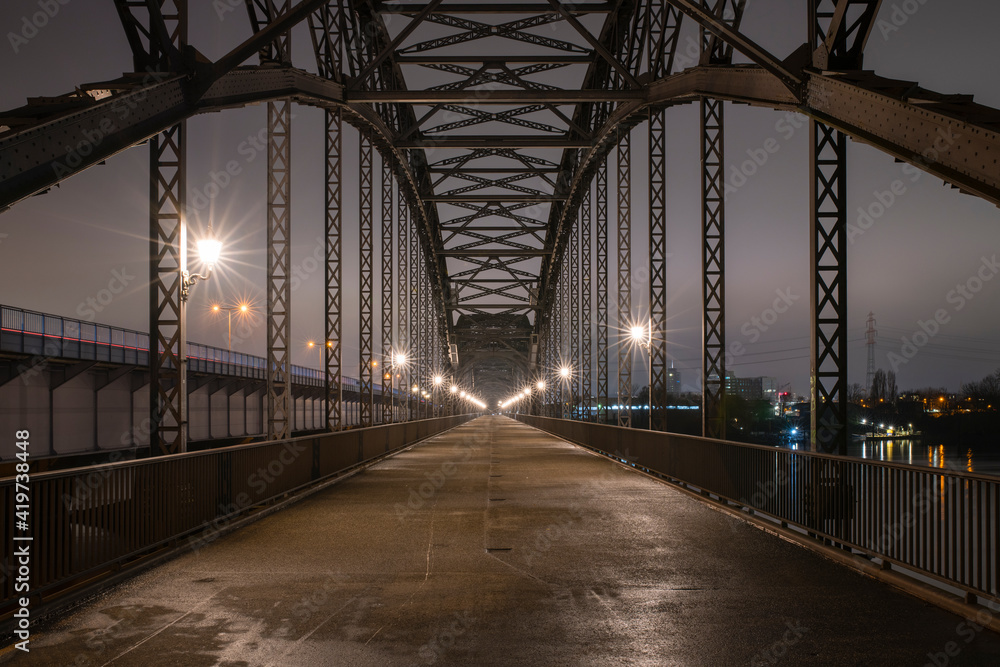 Germany, Hamburg, Diminishing perspective ofÔøΩAlte Harburger Elbbrucke bridge at night Germany, Hamburg, Diminishing perspective ofÔøΩAlte Harburger Elbbrucke bridge at night