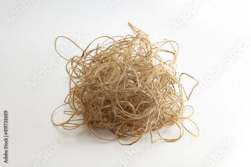 Tangled mess. Unorganized, stress, confused, complicated, concept image. Large ball of tangled and hemp string isolated on neutral white background.