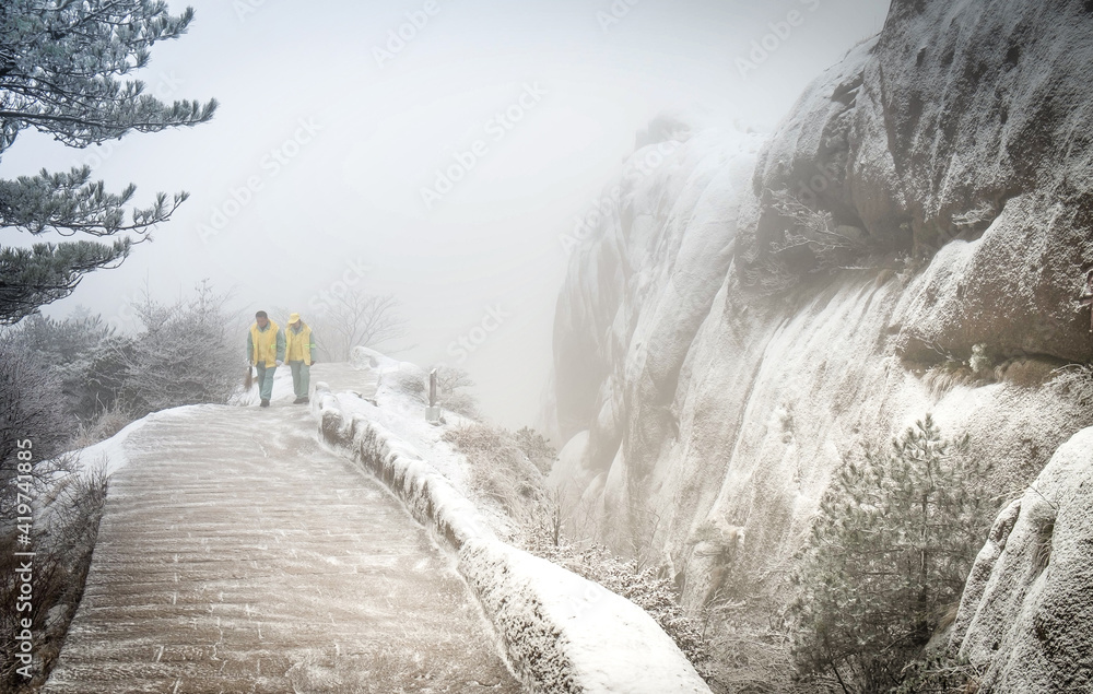 The couple worker that prepare for cleaning up along the walkway at Huangshan mountain or yellow mountain.