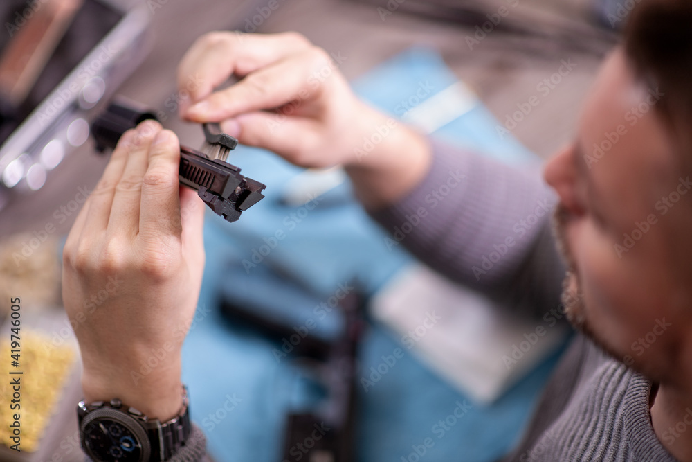 Man cleaning gun Man cleaning gun