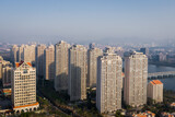 Aerial view of modern city skyline beside the river at sunrise in Jimei District, Xiamen, China