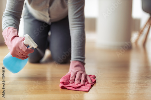 Woman cleaning and mopping floor at home