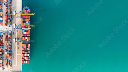 Aerial top view Of Containers cargo ship. Business logistic transportation sea freight, Cargo ship, Cargo container in deep sea port at industrial estate for import export around in the world