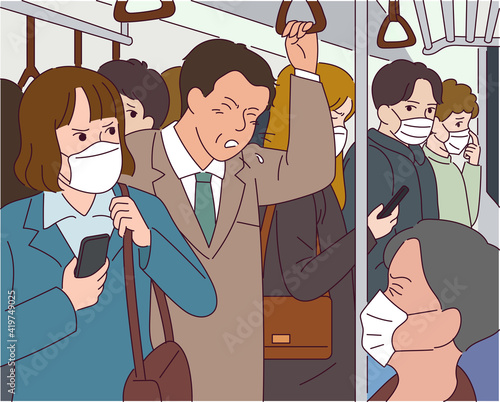 A man coughs in the subway, all of the passengers wearing masks.