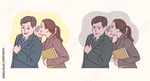 An office worker is whispering to a colleague.