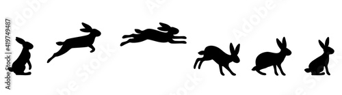A set of rabbit jump phases. The hare sits, prepares to jump, jumps, lands. Black silhouette on a white background. Vector illustration.