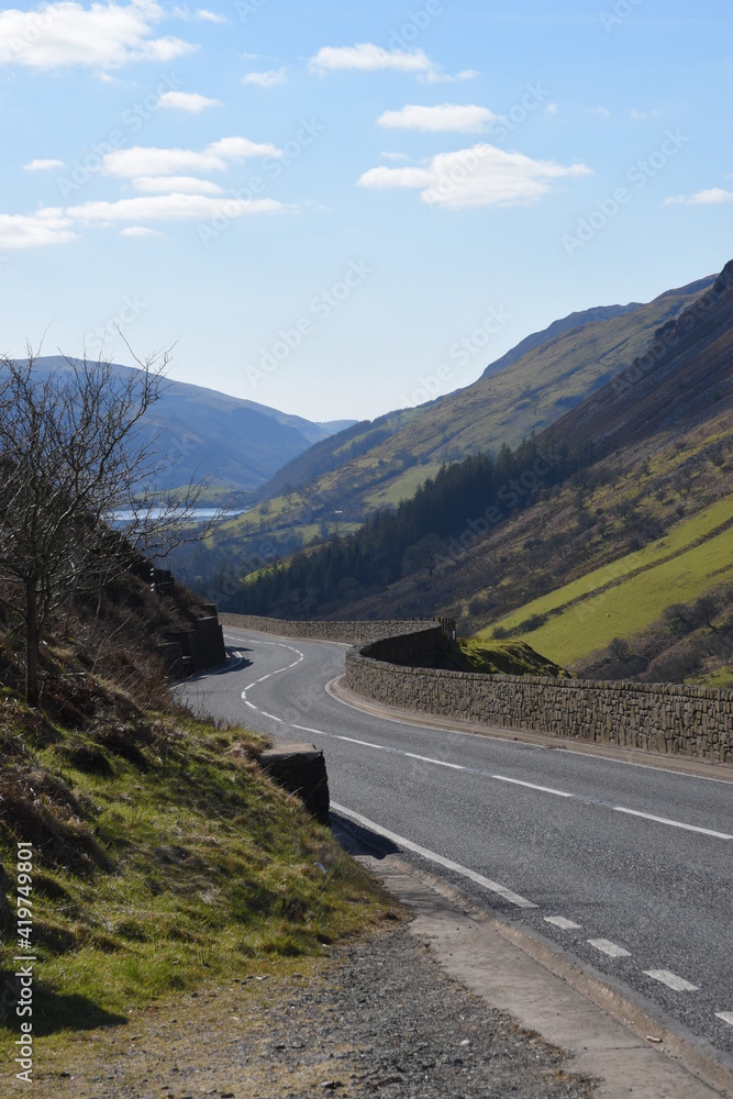 a steep and dangerous road near Cadair Idris with mountains either side and tal-y-llyn lake in the background