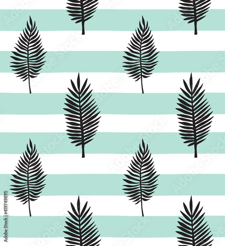 Vector seamless pattern of hand drawn palm leaves silhouette isolated on mint stripped background