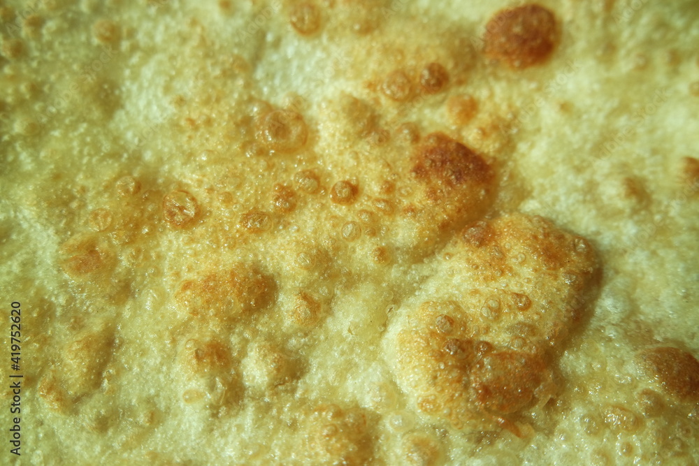 Closeup view of hand made plain bread in oil called paratha roti.