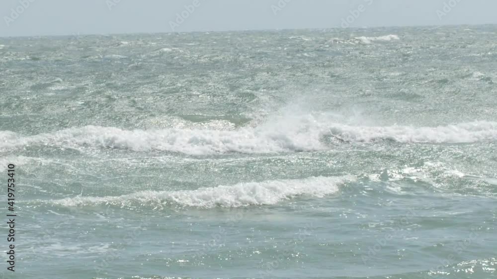 Unrecognizable man diving and swimming in the wavy sea at daytime. Unrecognizable man diving and swimming in the wavy sea at daytime.