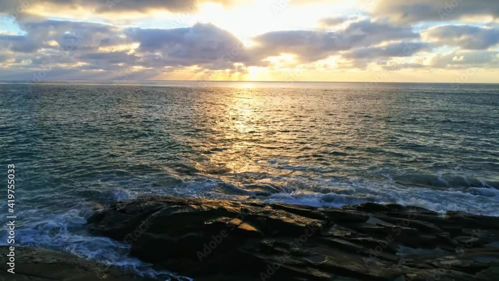 The view of rippling sea at sunset with reflections of the sun on it The view of rippling sea at sunset with reflections of the sun on it