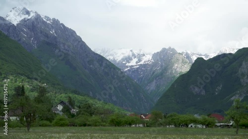 Snowy Alpine Mountains And Quiet Village In Slovenia - panning shot photo