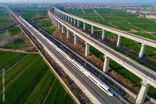 Huaian City, Jiangsu Province, China, a high-speed rail train from the field and fly by.