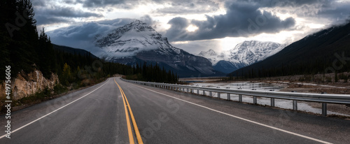 Beautiful panoramic view of a scenic road in the Canadian Rockies during Fall Season. Dramatic Sunset Sky Art Render. Taken in Icefields Pkwy, Jasper, Alberta, Canada.