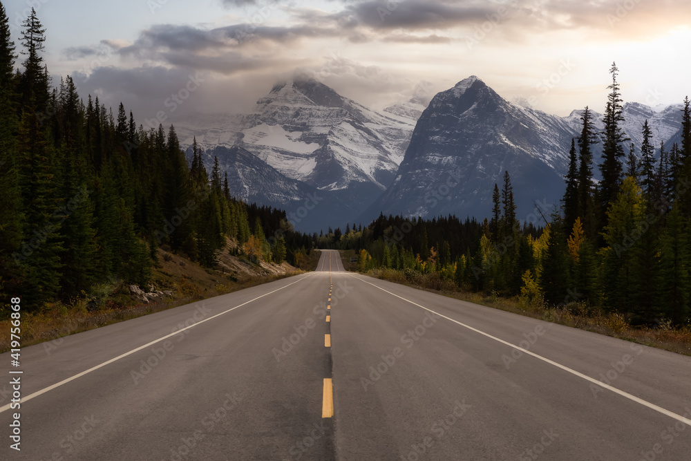 Fototapeta premium Scenic road in the Canadian Rockies during a vibrant sunny and cloudy summer morning. Artistic Sky Render. Taken in Icefields Parkway, Jasper National Park, Alberta, Canada.