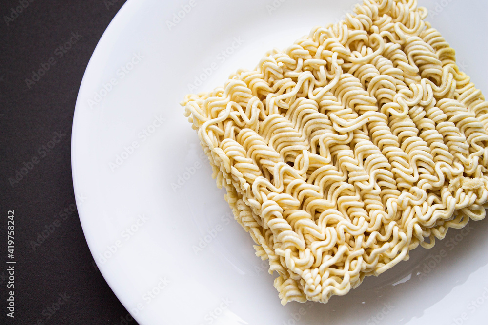 Noodles on a plate. Vermicelli in the shape of a square on a round plate. Noodles on a plate. Vermicelli in the shape of a square on a round plate.