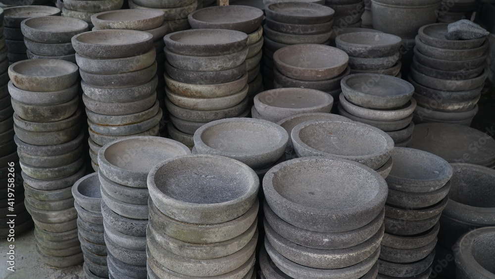 The group of Stone mortar without pestle for sale at local market in Indonesia The group of Stone mortar without pestle for sale at local market in Indonesia