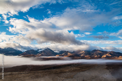 dramatic autumn landscape photo of he mountain peaks and valleys inside the Denali National Park in Alaska