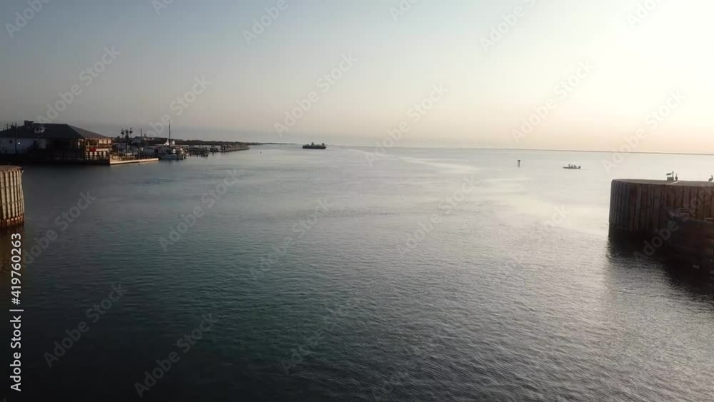 Aerial drone view 0f shipping channel of the Gulf Intercoastal Waterway in northern Laguna Madre; flying under the JKF Causeway bridge along the shore line; North Padre Island, Corpus Christi Texas Aerial drone view 0f shipping channel of the Gulf Intercoastal Waterway in northern Laguna Madre; flying under the JKF Causeway bridge along the shore line; North Padre Island, Corpus Christi Texas
