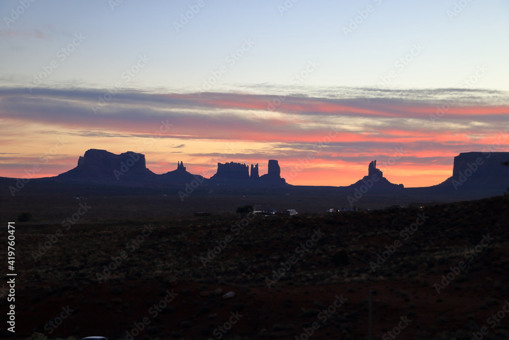 Orange clouds at sunrise in Monument Valley, Arizona