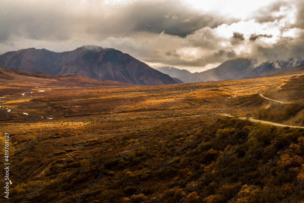 dramatic autumn landscape photo of he mountain peaks and valleys inside the Denali National Park in Alaska