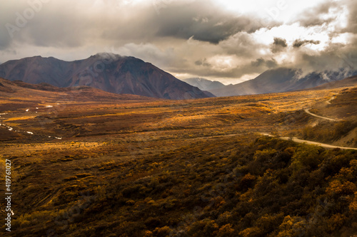 dramatic autumn landscape photo of he mountain peaks and valleys inside the Denali National Park in Alaska