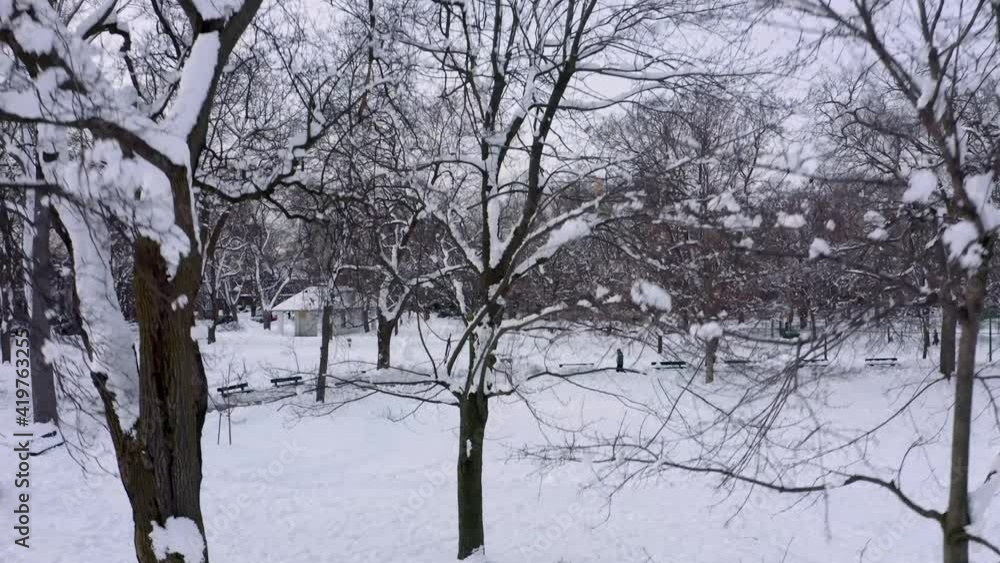 Drone starting from ground level and moving up revealing a residential neighbourhood in a snowy Montreal winter Drone starting from ground level and moving up revealing a residential neighbourhood in a snowy Montreal winter