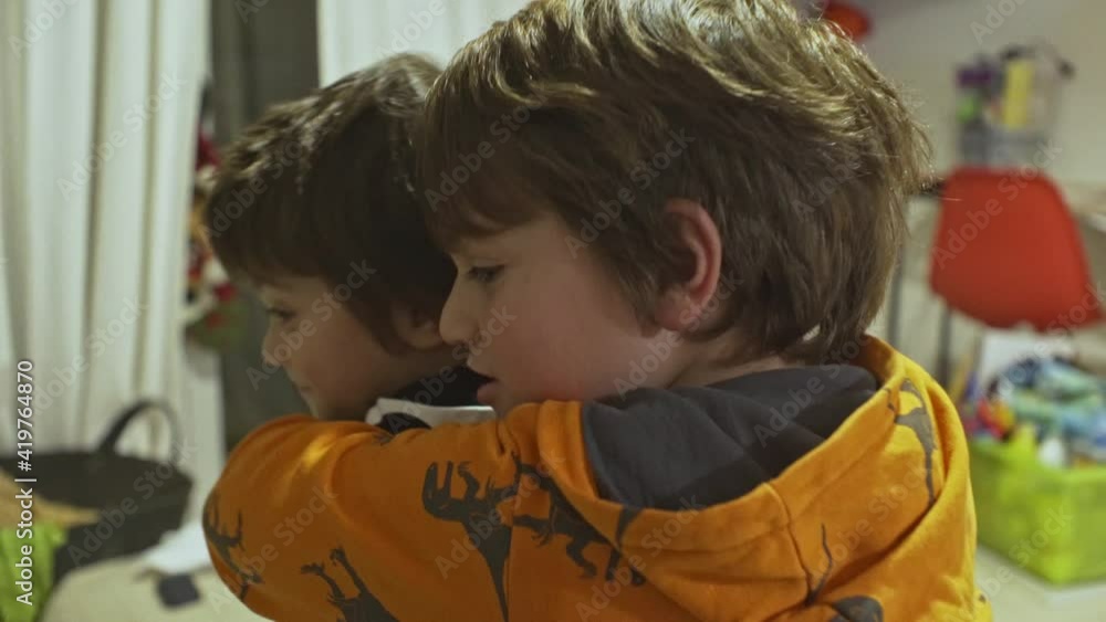 Close up of two cute caucasian greek brothers hugging and cherises each other at home. Close up of two cute caucasian greek brothers hugging and cherises each other at home.