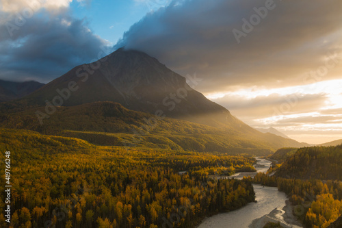 dramatic autumn sunset by the mountain range in Matanuska River in Alaska.