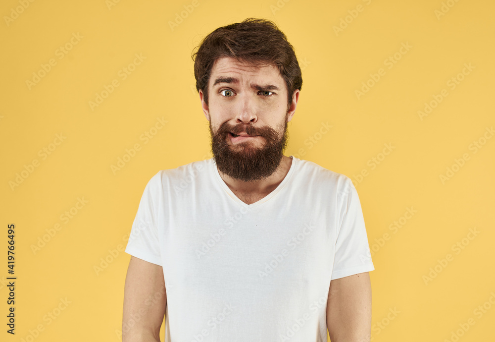 portrait of a man white t-shirt yellow background cropped view Copy Space portrait of a man white t-shirt yellow background cropped view Copy Space