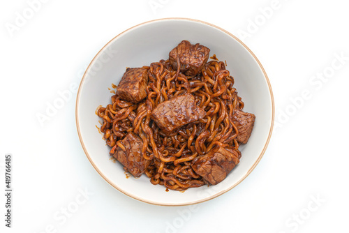 Jjapaguri or Chapaguri, Korean Black Beans Spicy Noodles with Beef on white background