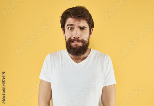 portrait of a man white t-shirt yellow background cropped view Copy Space
