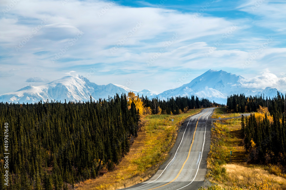 open highway in Alaska going to  the snow capped mountain of the Wrangell St Ellias mountain range taken during autumn.