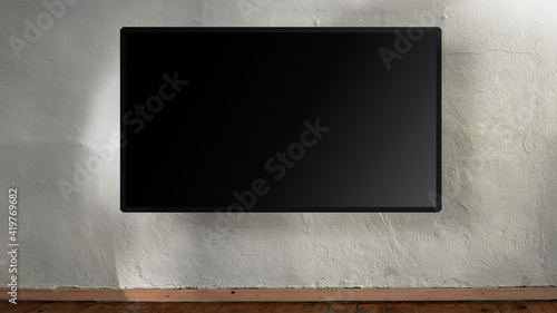 Tableau sur toile Large empty black flatscreen hanging on white concrete wall.